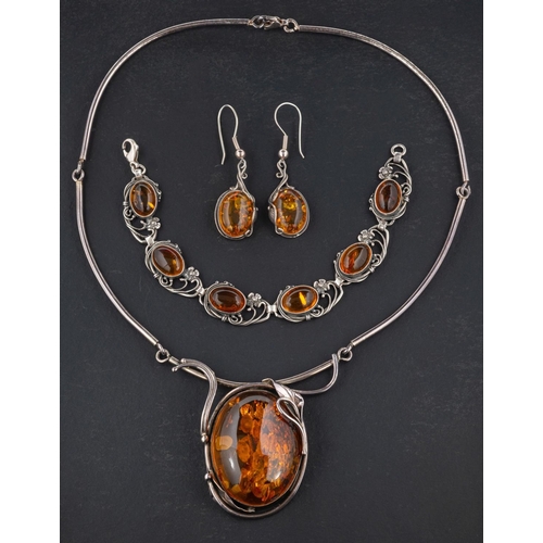 2517 - A oval amber necklace, bracelet and pair of earrings, with applied floral and foliate decoration, th... 