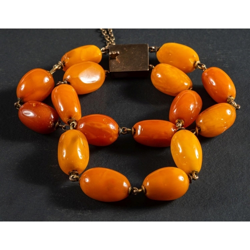 2521 - A two-strand, amber bead bracelet, diameter of beads ca. 9.5-12.2mms, total length ca. 19.5cm, total... 