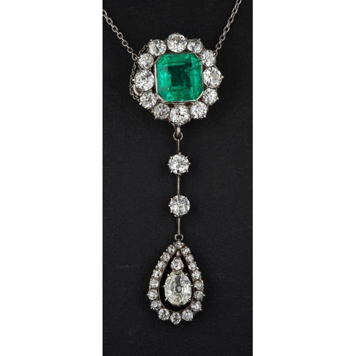 2976 - An octagonal step cut emerald  and old-cut diamond cluster with pear-shaped diamond drop pendant nec... 