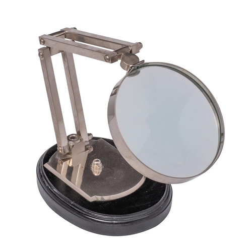 336 - A chrome plated angle-poise  desk magnifying glass with 12cm circular lens mounted on an ebonised ov... 