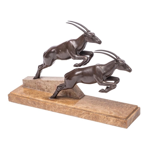 339 - An Art Deco bronze patinated metal group of two leaping gazelles mounted on a polished marble base, ... 