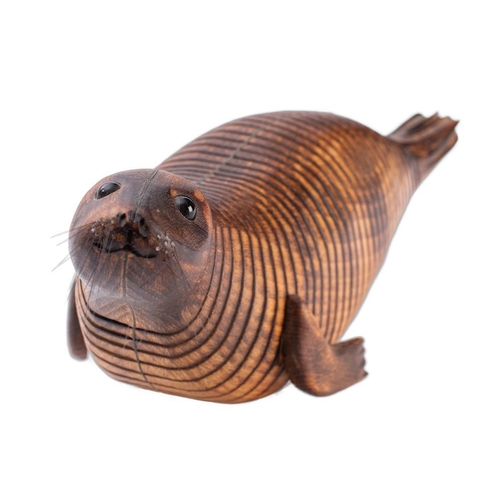 340 - Almost certainly Jeff Soan, (British, contemporary), an articulated beechwood model of a seal, with ... 