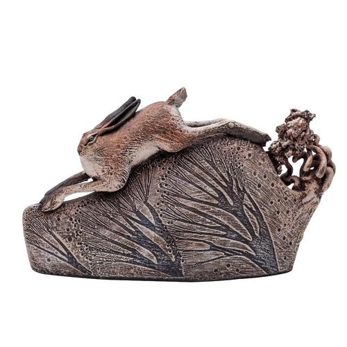 100 - *Blandine Anderson [Contemporary] a stoneware sculpture of a running hare the hill with willow trees... 