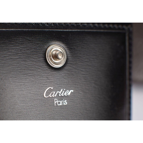 822 - Cartier, Paris. A boxed black leather compact case with  instructions and card number LL 054374. tog... 