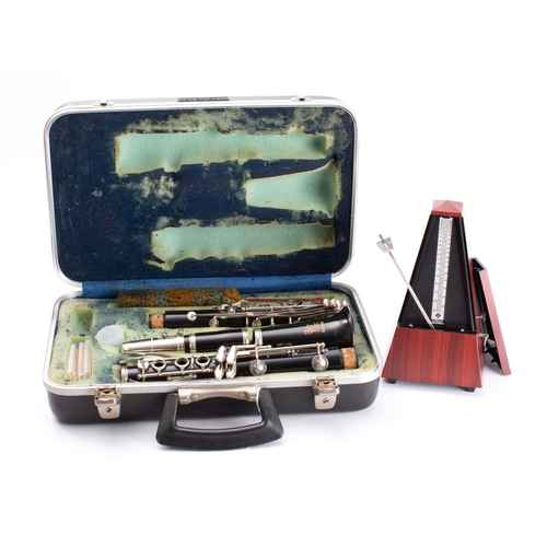 1063 - A Bousey & Hawkes 'Regent' clarinet in case,  together with a Wittner metronome. (2)