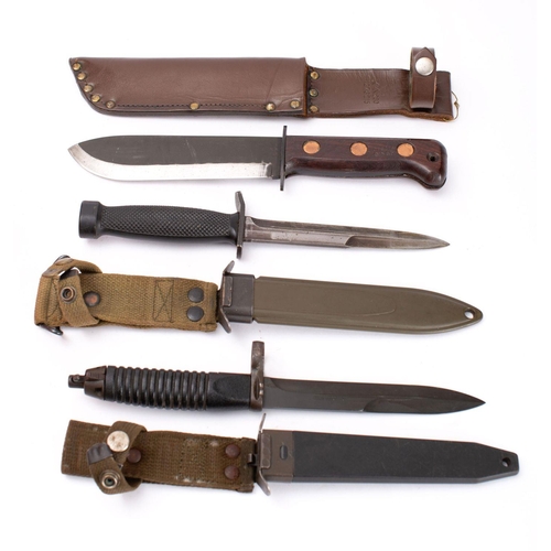 216 - A NATO Type-D Fighting Knife,  the blackened single edge blade over a oval hilt and two piece wooden... 