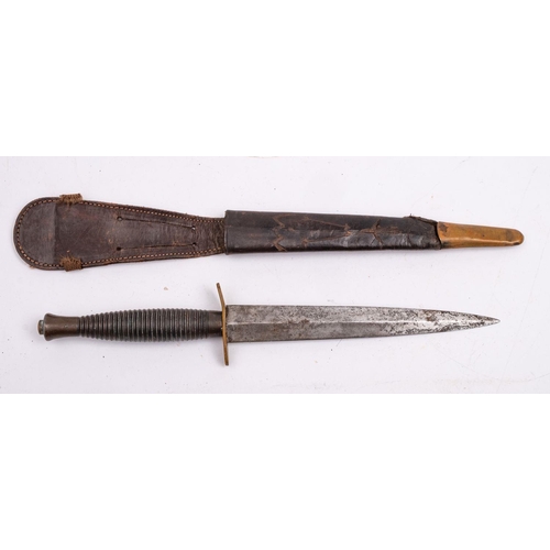 224 - A Fairbairn Sykes Third Pattern Fighting knife,  the straight double edged blade over an oval hilt a... 