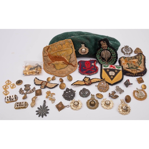 306 - A collection of cap badges and insignia,  including a Royal Marines green beret , Dorset Regiment ca... 