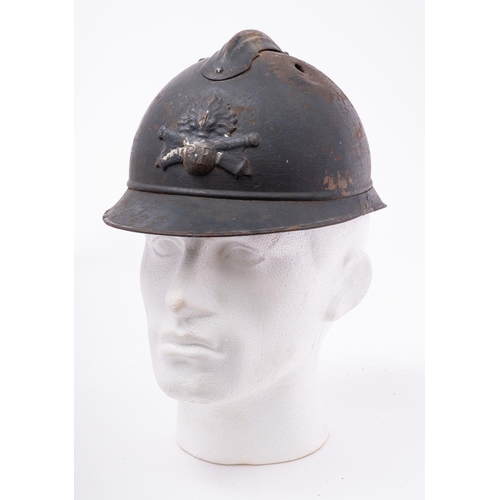 334 - A WWI French Artillery M15 Adrian steel helmet of three piece construction with comb and 'RF' helmet... 