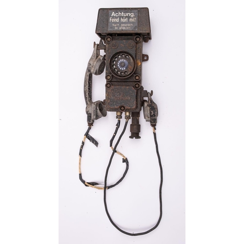 335 - A WWII German Bunker cast iron telephone by Siemens, the bell cover with label 'Achtung, Fiend hort ... 