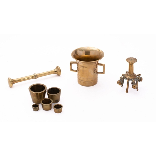 45 - A part set of late 19th century concentric weights,  together with a brass pestle and mortar, a rose... 