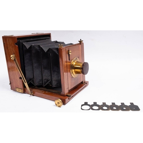 556 - A Perkin Son & Rayment  mahogany and brass half plate field camera,  fitted lens engraved 'Made Abro... 