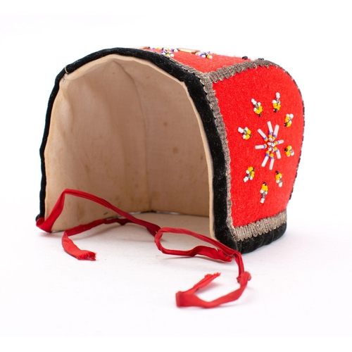 813 - An early 20th century Scandinavian child's bonnet: with traditional beaded decoration.