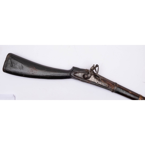 174 - An 18th/19th century Indo-Persian flintlock jezail, 46 inch copper banded barrel with sidelock actio... 