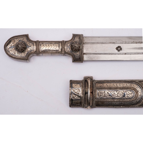 230 - A white-metal  mounted jambiya, the straight double edge blade with fuller, over a traditional style... 