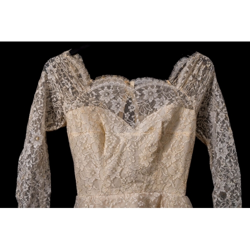 826 - A mid 20th century lace and satin long-sleeve wedding dress  in original retailer's box 'Rockheys To... 