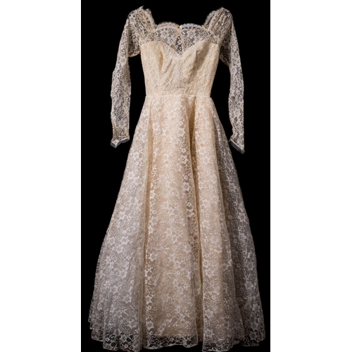 826 - A mid 20th century lace and satin long-sleeve wedding dress  in original retailer's box 'Rockheys To... 