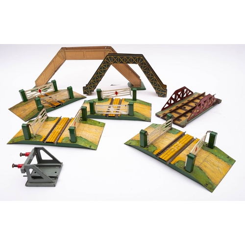 981 - An unboxed group of four Hornby O gauge  railway crossings,  together with a railway bridge, two foo... 