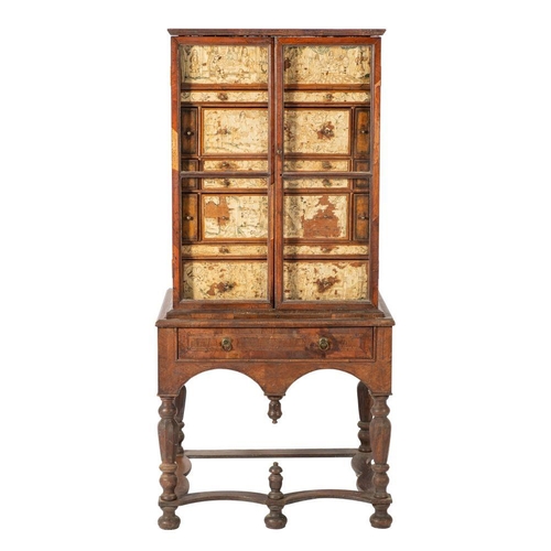 998 - A walnut and embroidery adorned cabinet on stand, elements 17th century and later; the hinged top an... 