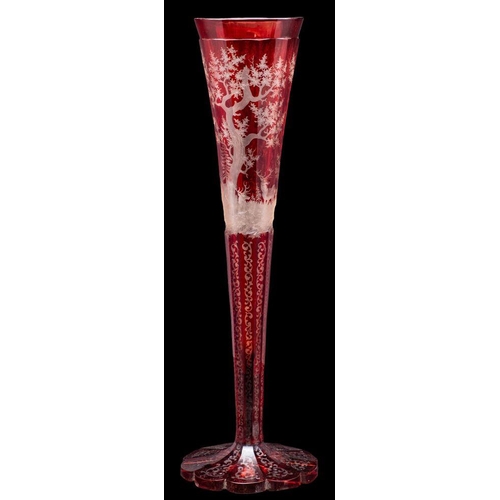 1 - A Bohemian red overlay glass vase, of faceted trumpet shaped form on a petal base intaglio decorated... 