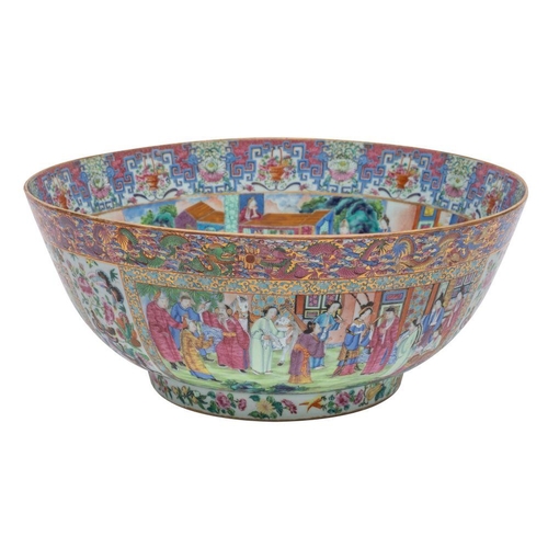 101 - A large Canton punch bowl richly enamelled overall with elaborate Court scenes within bands of drago... 