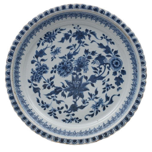 109 - A Chinese blue and white dish with moulded foliate rim, painted with sprays of chrysanthemum, peony,... 