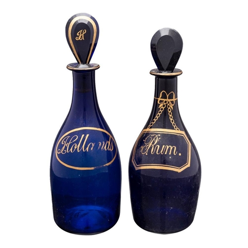 11 - Two 'Bristol Blue' mallet shaped decanters, with lozenge shaped stoppers decorated with gilt labels ... 