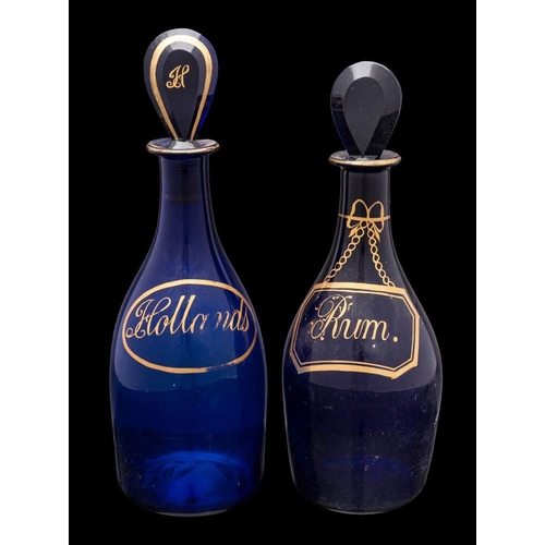 11 - Two 'Bristol Blue' mallet shaped decanters, with lozenge shaped stoppers decorated with gilt labels ... 