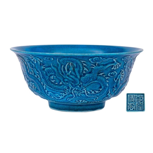 116 - A Chinese blue ground 'Dragon' bowl: the exterior decorated in relief with three scally dragons amon... 