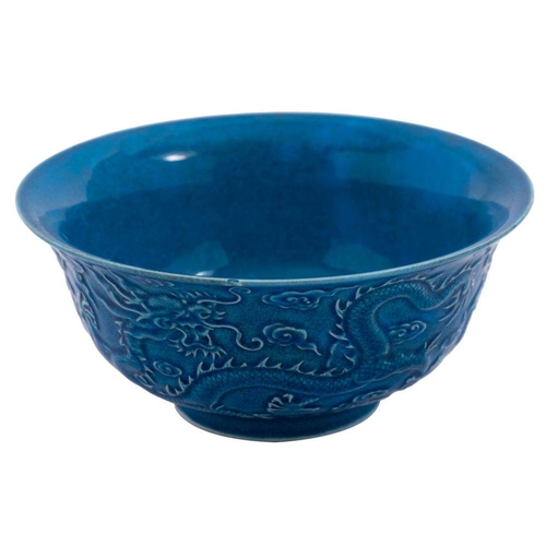 116 - A Chinese blue ground 'Dragon' bowl: the exterior decorated in relief with three scally dragons amon... 