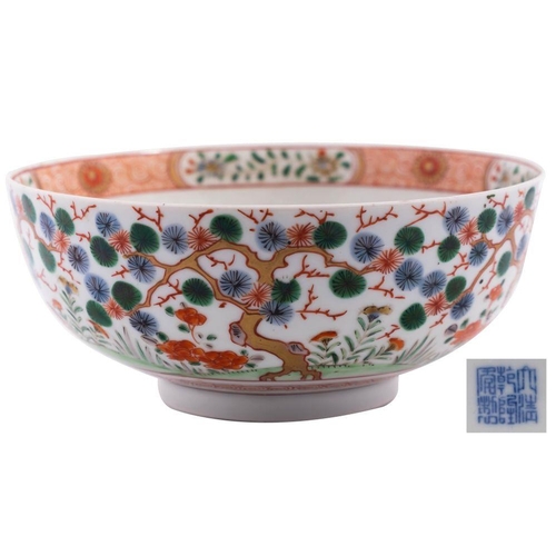 119 - A Chinese porcelain bowl the exterior decorated with aged pine and peony, the interior with peony an... 