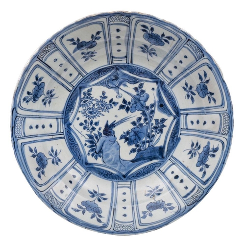 122 - A Chinese 'Kraak' blue and white dish painted with a bird, rockwork and flowering plants within a st... 