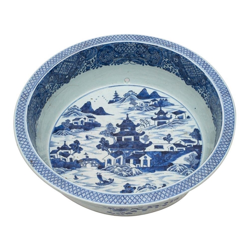 123 - A large Chinese blue and white basin painted with an extensive pagoda lake landscape within an elabo... 