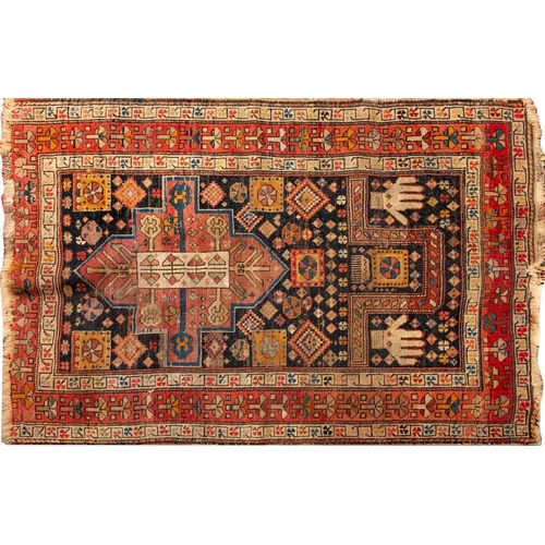 1372 - A Shirvan Prayer Rug,  the indigo geometric mihrab with a hand to either side and with a rose geomet... 