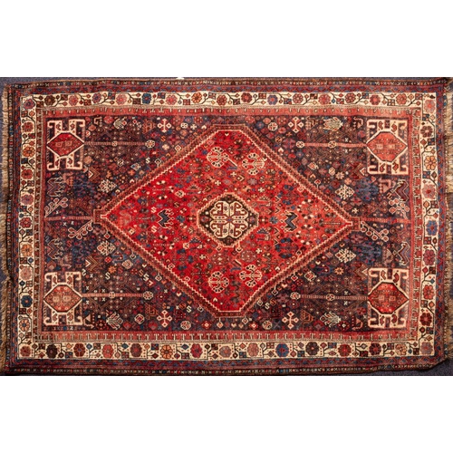 1379 - A Shiraz Rug the indigo field with a brick red hexagonal medallion, all over geometric designs and m... 