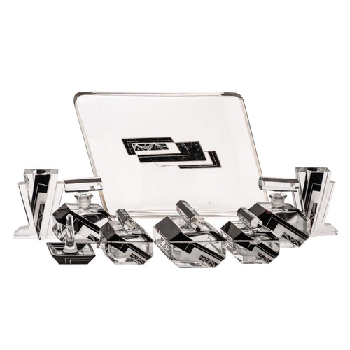 14 - An Art Deco clear glass dressing table set, comprising a trapezoidal tray, five hexagonal powder box... 