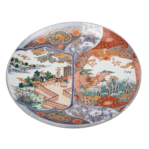 147 - A pair of Japanese Arita porcelain chargers, of generous proportions each decorated in underglaze bl... 