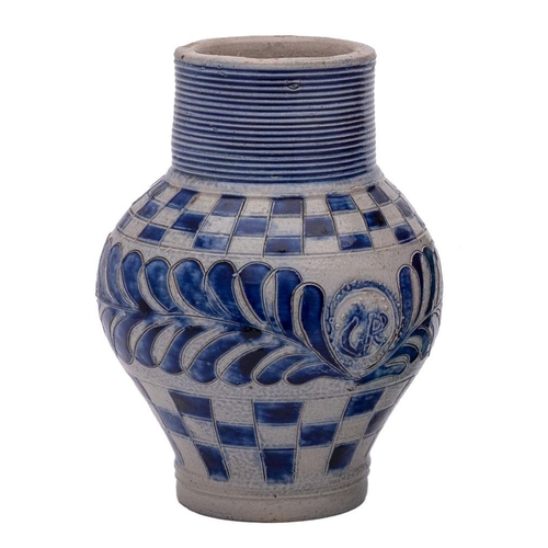 159 - A German Westerwald blue and grey stoneware 'GR' jug with ribbed neck, incised with chequer bands an... 