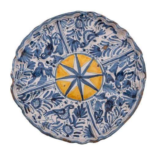 161 - An Italian maiolica tazza with wide moulded rim, painted in blue with a  sunburst medallion on a yel... 