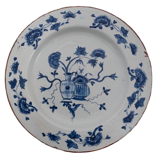 173 - A mixed lot of Dutch delftware comprising four blue and white chargers and a plate variously painted... 