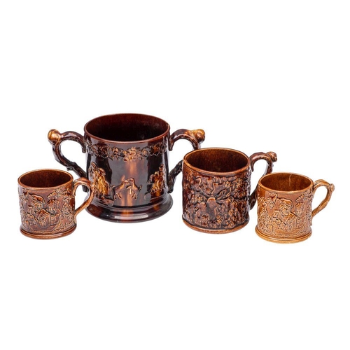 179 - A large 19th century treacle-glazed frog loving-cup, three similar and seven other frog mugs,  the f... 