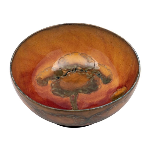 191 - A William Moorcroft bowl the interior and exterior tube lined in warm tones in the Eventide pattern,... 