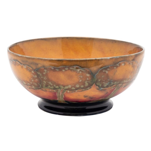 191 - A William Moorcroft bowl the interior and exterior tube lined in warm tones in the Eventide pattern,... 