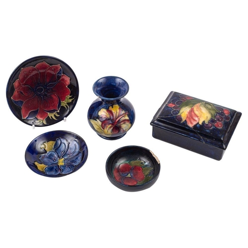 196 - Five pieces of Moorcroft pottery, comprising a small vase in the Hibiscus pattern, a box and cover d... 