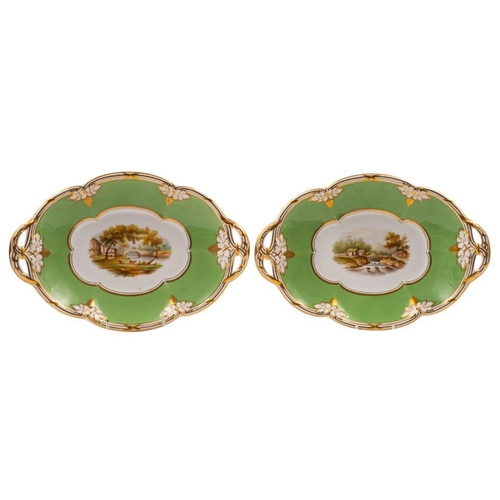 244 - A pair of Davenport porcelain two-handled oval dessert dishes painted with river landscapes within g... 