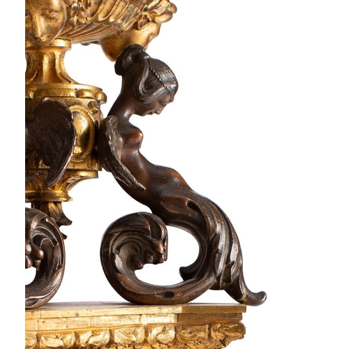 430 - A pair of French patinated and parcel gilt bronze six light candleabra, in Neoclassical style, circa... 