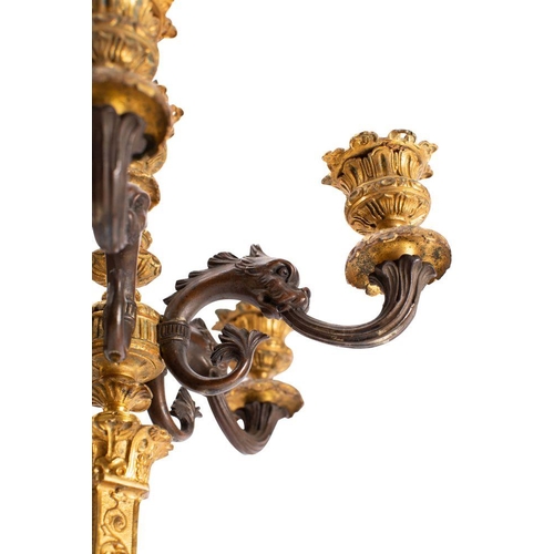 430 - A pair of French patinated and parcel gilt bronze six light candleabra, in Neoclassical style, circa... 