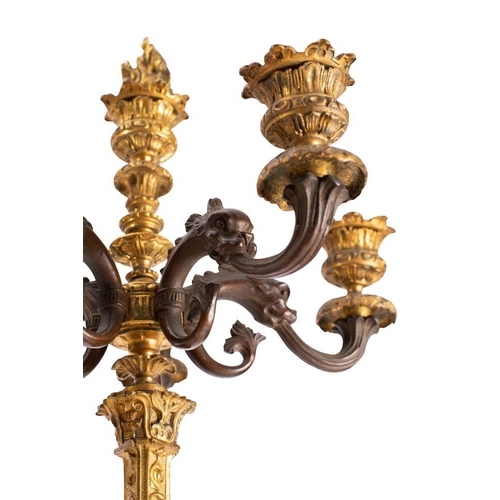 430 - A pair of French patinated and parcel gilt bronze six light candleabra, in Neoclassical style, circa... 