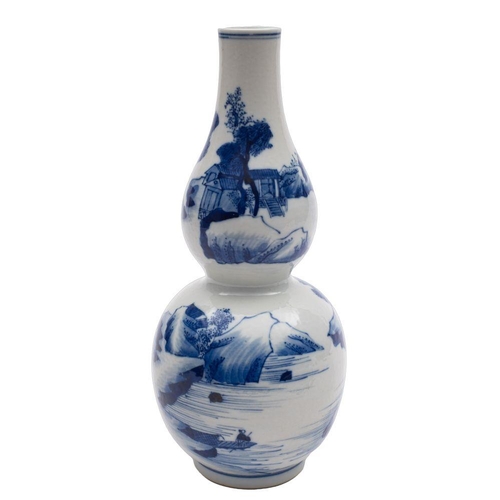 48 - A Chinese blue and white double gourd vase painted with mountainous lake landscapes with buildings a... 