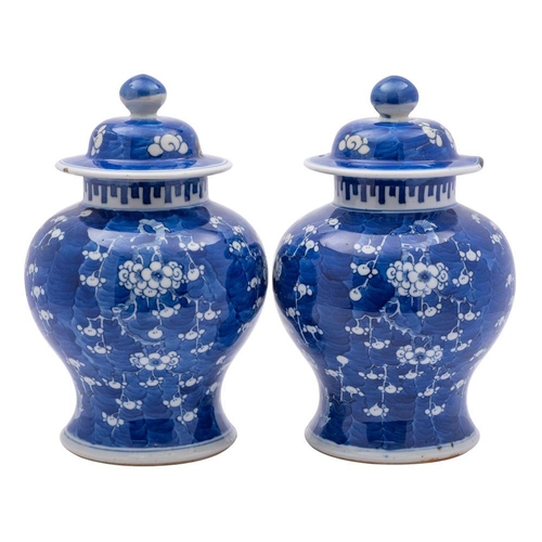 57 - A pair of Chinese blue and white baluster jars and covers, late Qing Dynasty painted with prunus blo... 